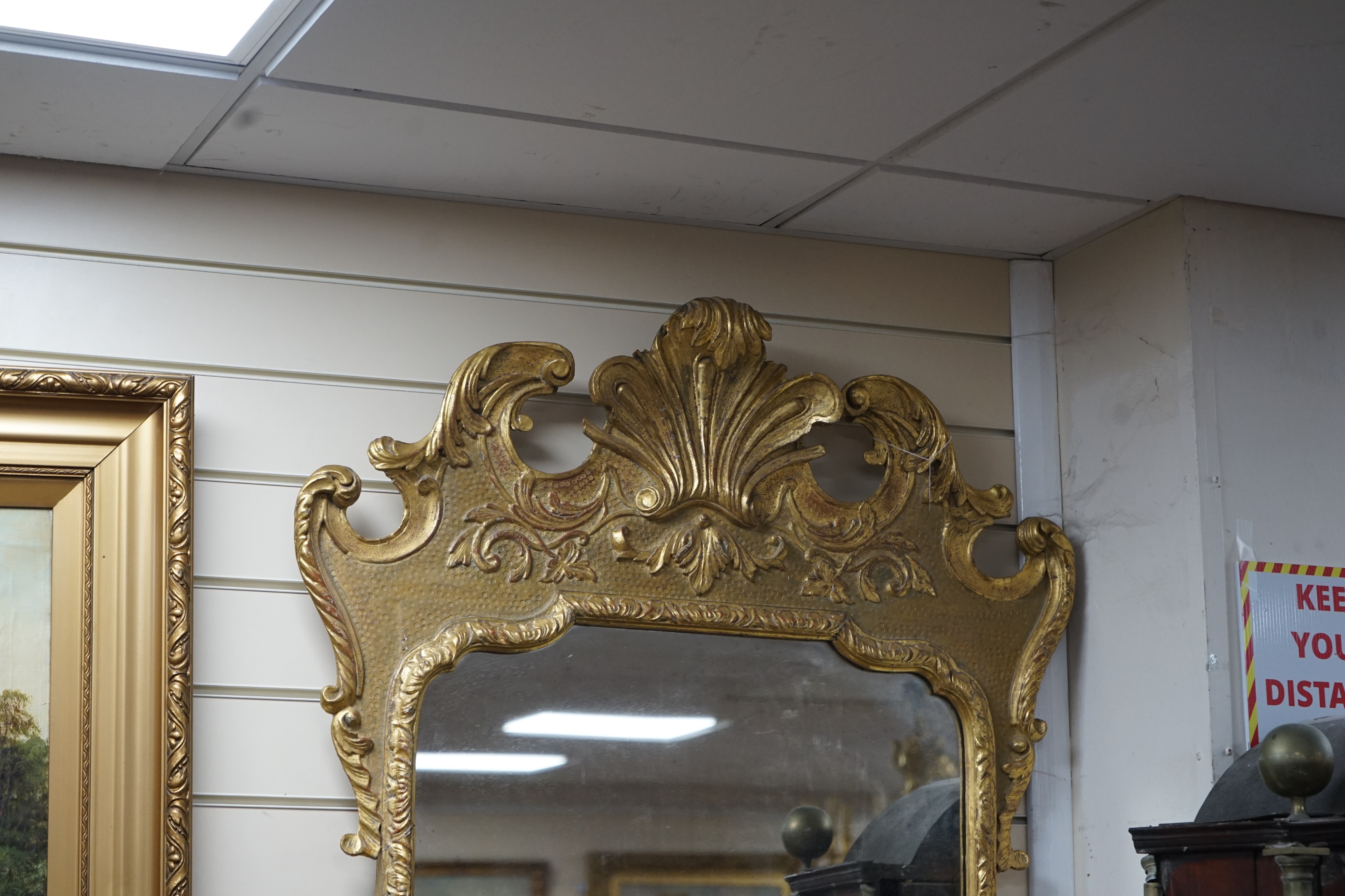 A George II style carved giltwood and composition wall mirror, width 76cm, height 135cm
